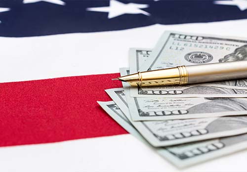Dollar Bills With Pen On American Flag
