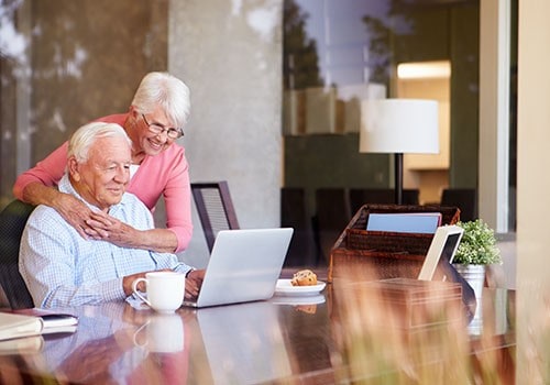 An elderly couple looking up information about Social Security on ssofficelocation.com