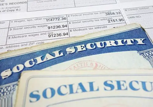 A social security card on top of a paystub.