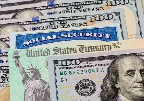 Social Security Card Treasury Check And 100 Dollar Bills On Desk
