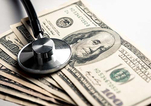 Stethoscope On Background Of Money Medicare Concept
