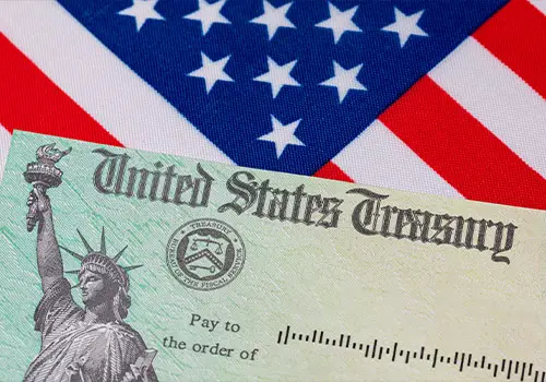 United States Treasury Check And American Flag Social Security Concept