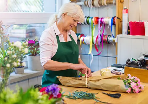 Self Employed Elderly Woman Working In Florist Shop