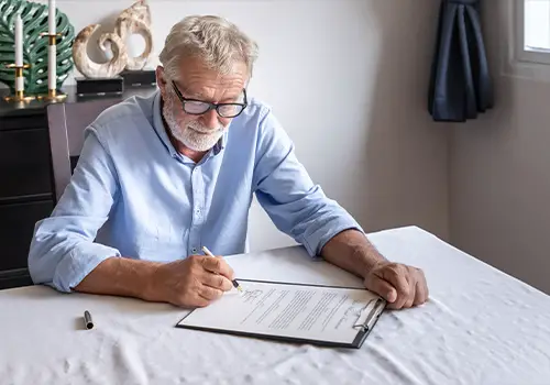 Senior Elderly Man Signing Last Will And Testament