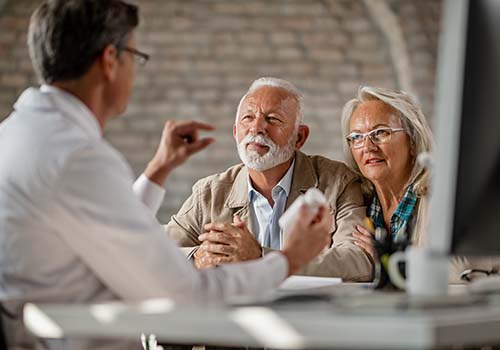 Senior Couple Consulting With A Medical Professional