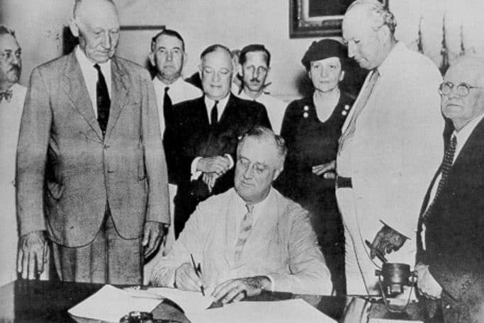 President Franklin D. Roosevelt signing the Social Security Act into law in 1935.