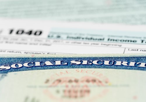 A Social Security card on top of a 1040 tax form.