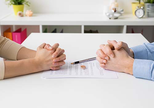 Couple Going Through Divorce Signing Papers