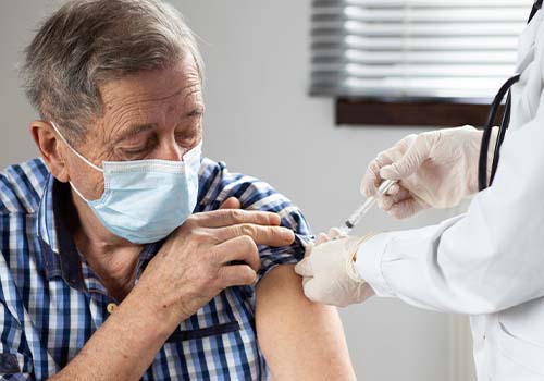 Elderly Person Receiving Shingles Vaccine From Doctor