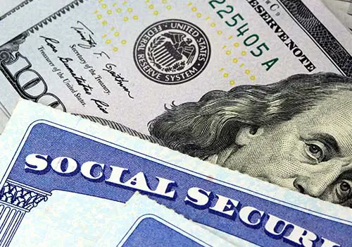 Social Security Card On Top Of Hundred Dollar Bill