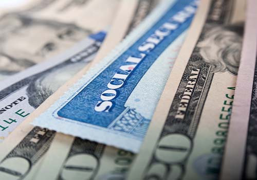 Social Security Card Under Various Dollar Bill Amounts