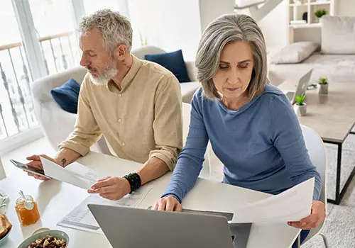 Elderly Man And Woman Reviewing Documents Together