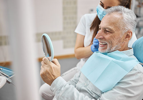 Elderly Man Smiling After Dental Procedure