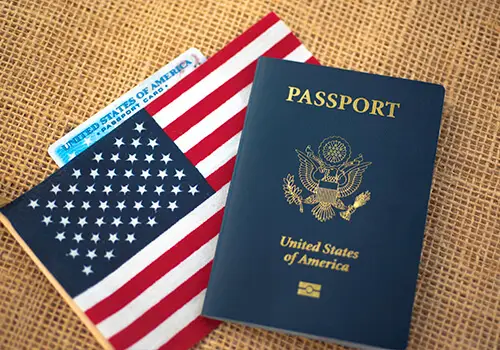 A USA passport on top of an American flag.