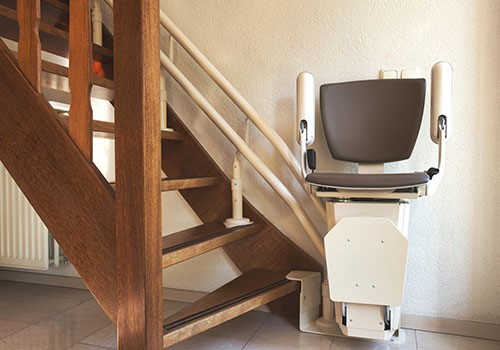 A stairlift at the bottom of the stairs.