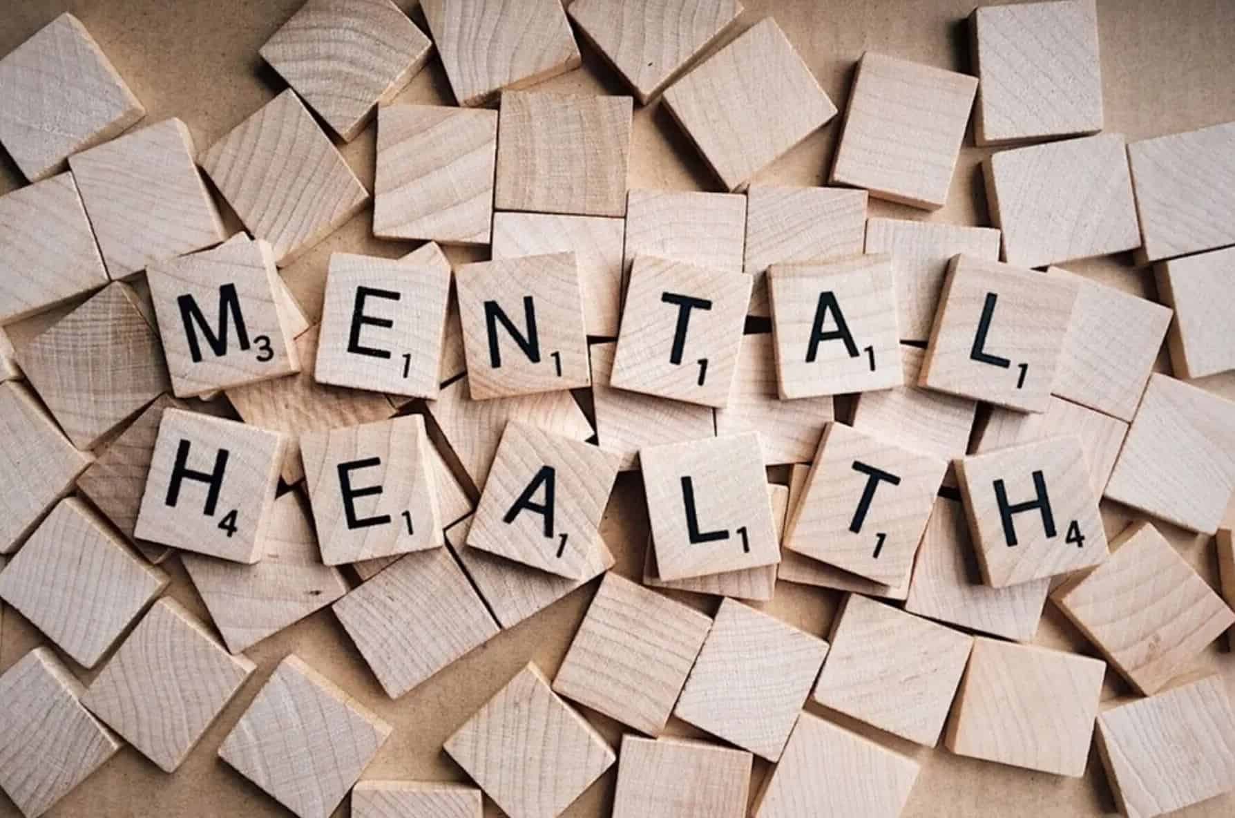 Mental Health spelled out with wooden scrabble tiles.