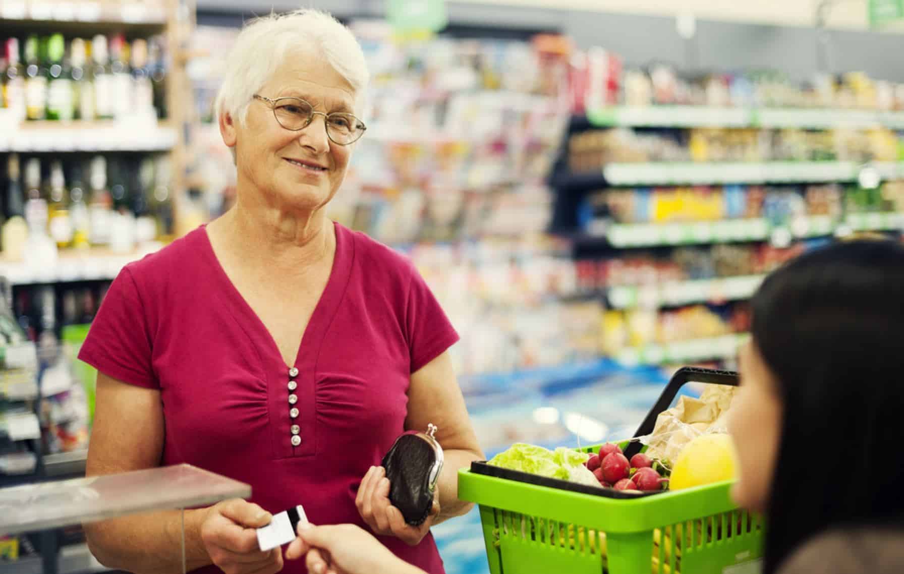 Paying for groceries with a Medicare Grocery Benefit card.